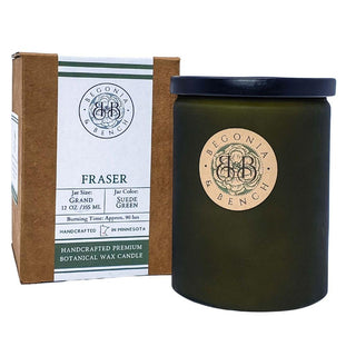 Introducing the Yuzami™ - a 12oz finely crafted scented candle by Begonia & Bench®. This premium botanical wax candle, housed in a dark green matte jar with a beige label, sits elegantly beside its brown cardboard box packaging. Both the label and box highlight the "Fraser" fragrance and emphasize that it is handcrafted in Minnesota, boasting an impressive burn time of approximately 90 hours.